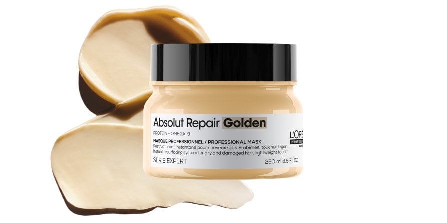Packshot of L’Oréal Professionnel Absolut Repair hair mask on a textured background, highlighting its rich, buttery texture for damaged hair.
