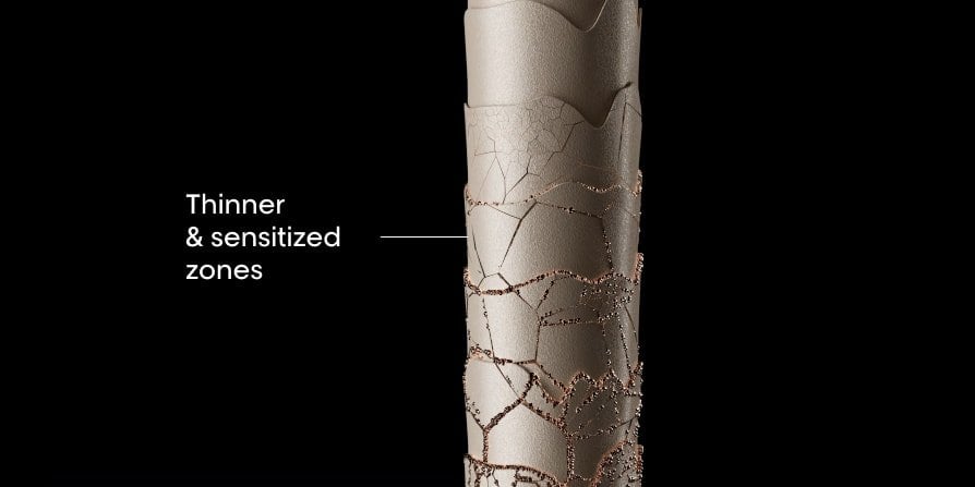 Close-up of damaged hair showing thinner, weakened strands and sensitized zones along the lengths, highlighting breakage-prone areas.